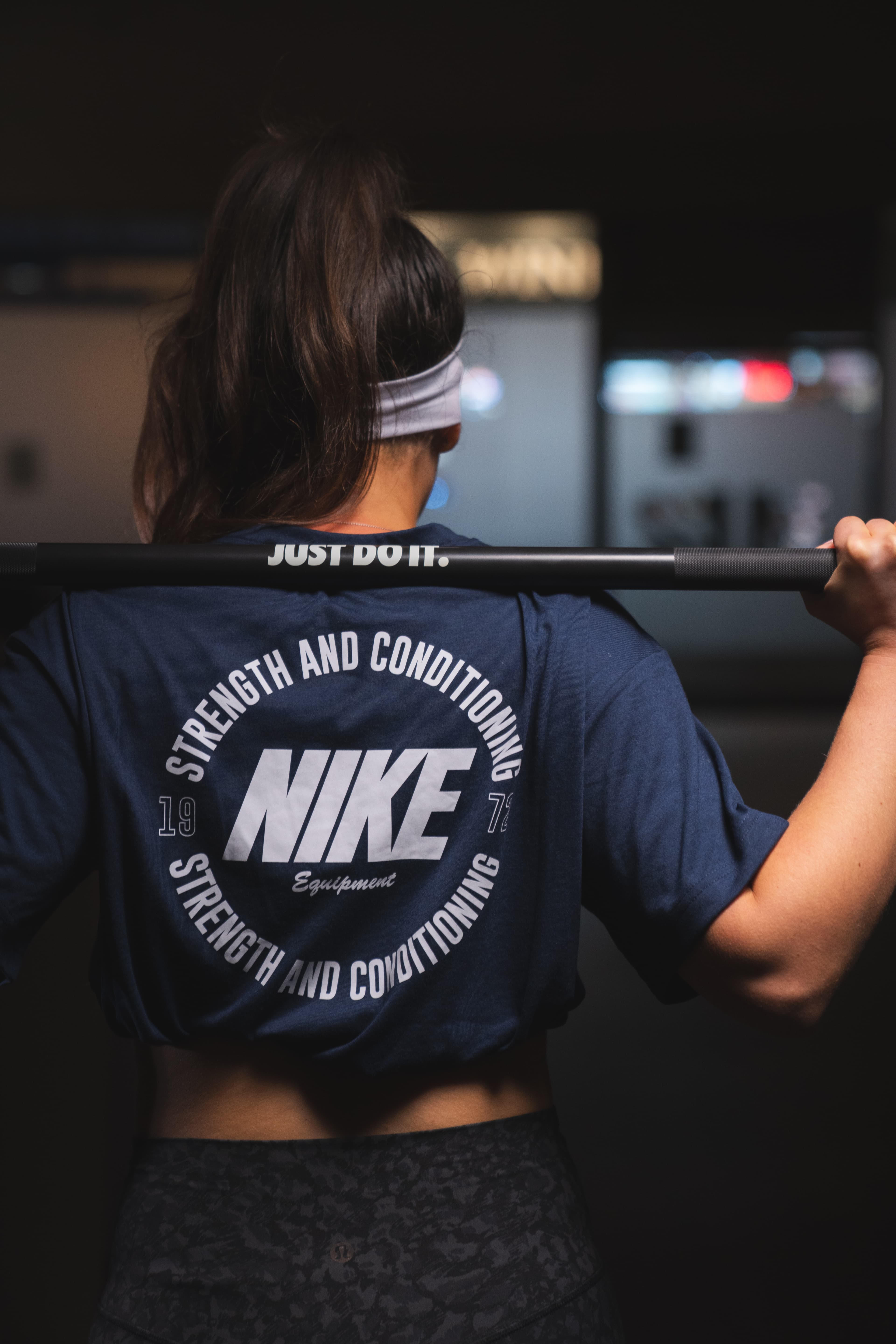An athlete performing a barbell back squat in the Studio 22 gym